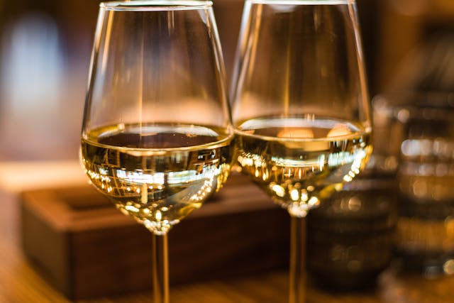 Two wine glasses filled with white wine